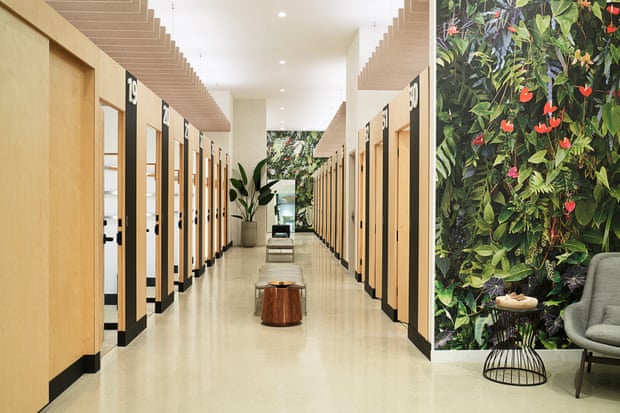 Inside Amazon Style a row of fitting rooms where all the doors are made of light-colored wood.