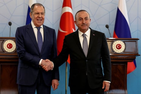 Russian foreign minister Sergei Lavrov and Turkish foreign minister Mevlut Cavusoglu shake hands as they attend a news conference in Ankara.