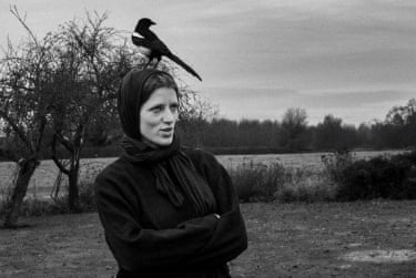 Muse and Magpie, West Sussex, 2016 - a magpie perches on Janina’s head in a scene of open land