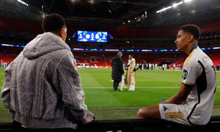 Jude Bellingham sits with his brother, Jobe, as their parents Mark and Denise talk in the background after the Champions League final.