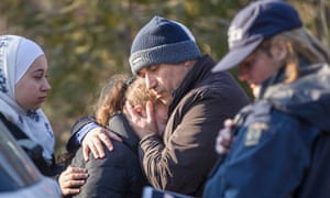 A man from Syria hugs his daughter after they were detained by the RCMP as they illegally crossed the US-Canada border near Hemmingford, Quebec, 28 February 2017. 