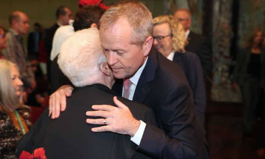 The opposition leader, Bill Shorten, hugs a member of the public