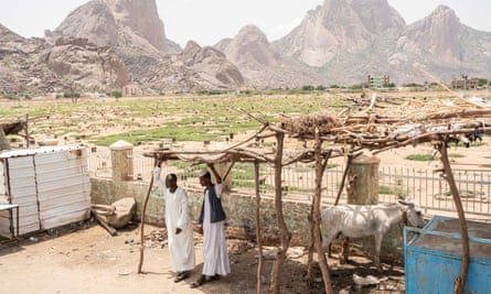 Sudanese stand in front of a cemetery near Altaka mountains in Kassala, Sudan