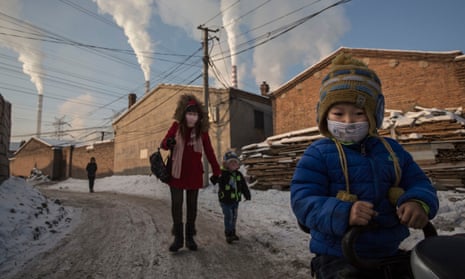 Shanxi residents wear masks for protection as smoke billows from coal stacks in 2015