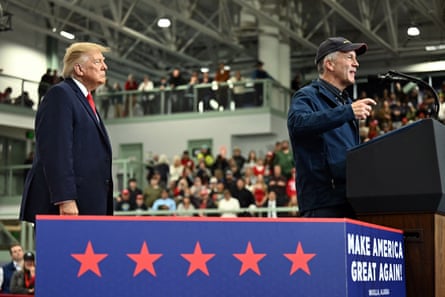 Donald Trump watching a man speak on stage