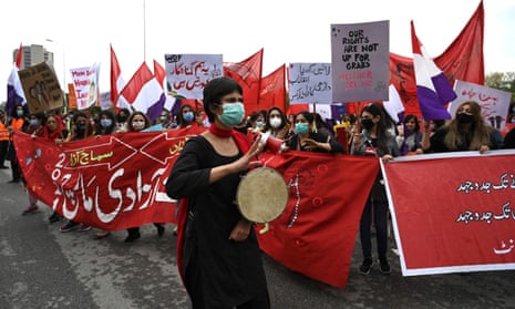 Marchers carry placards as they take part in the annual Aurat March in Islamabad on 8 March.