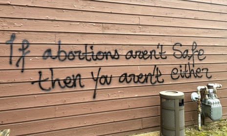 Threatening graffiti is seen on the exterior of Wisconsin Family Action offices in Madison, Wisconsin, on Sunday.
