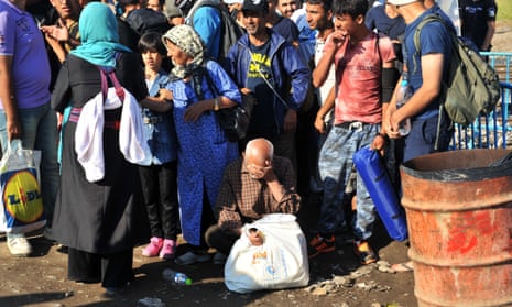 Asylum seekers wait to cross the Greece-Macedonia border