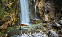 Hiker looking at waterfall, Accursed mountains, Theth, Shkoder, Albania, Europe<br>JXMWT4 Hiker looking at waterfall, Accursed mountains, Theth, Shkoder, Albania, Europe