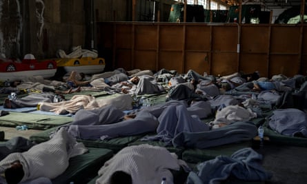 Survivors of a shipwreck at a warehouse in the port of Kalamata