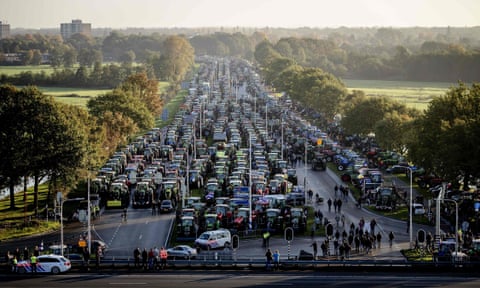 A huge traffic jam of hundreds of tractors reaches off into the distance as farmers protest against nitrogen policy rules in Bilthoven in the Netherlands in October 2019.