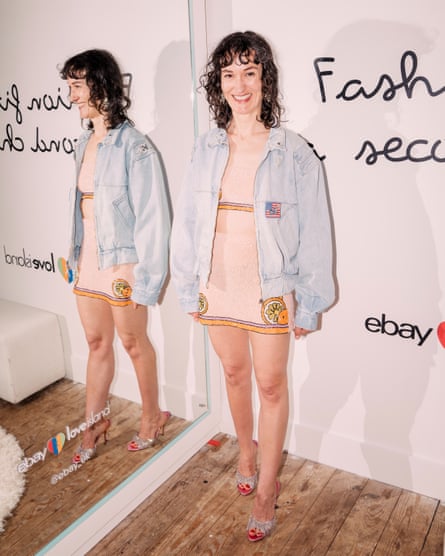 Lauren Cochrane wears a sequined crop top and mini skirt, and denim bomber jacket.
