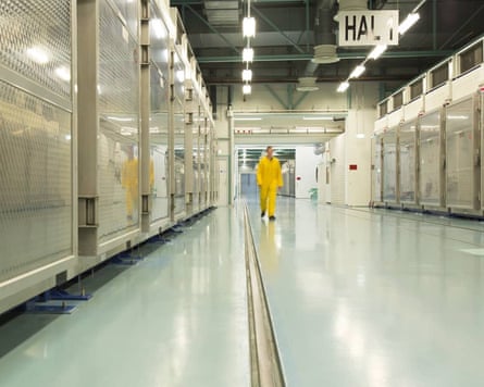 A man walks down a corridor in a nuclear facility