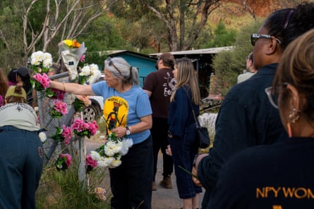 Mourners leave flowers at the entrance to the Old Timers camp in Alice Springs