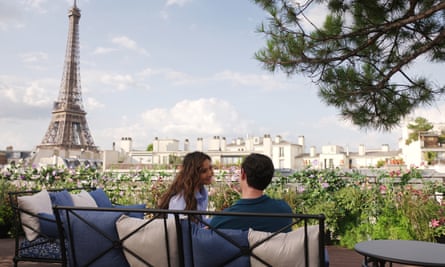 Couple sit on a terrace with the Eiffel Tower in the background