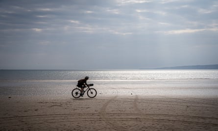 A cyclist on Filey beach.