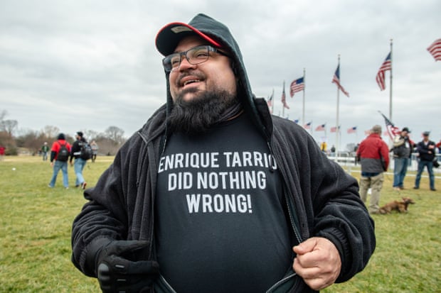 A Proud Boy displays an ‘Enrique Tarrio Did Nothing Wrong’ shirt as Trump supporters gather for the ‘Stop The Steal’ rally that preceded the Capitol assault on 6 January