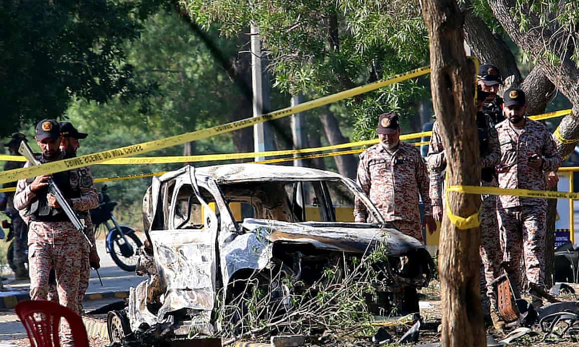 Security officials inspect the scene of a blast