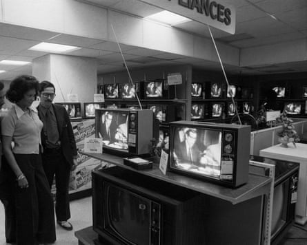 A man and female guidelines looking astatine nan proceeding showing connected TV screens successful an electricals store