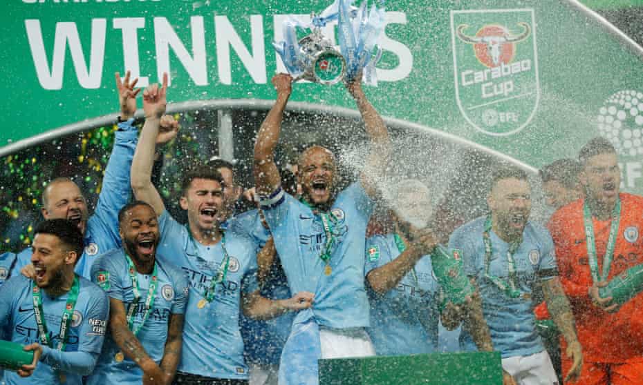 Manchester City players celebrate with the trophy after winning the Carabao Cup final against Chelsea.