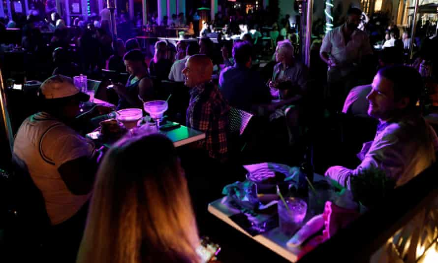 People gather at a bar during spring break festivities in Miami Beach.
