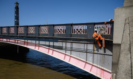 An engineer abseils from Lambeth Bridge, one of many London bridges in need of repair.