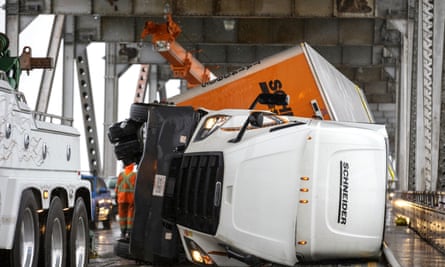 Crews work to upright an overturned semi-tractor-trailer truck on the Richmond-San Rafael Bridge, north of SanFrancisco.