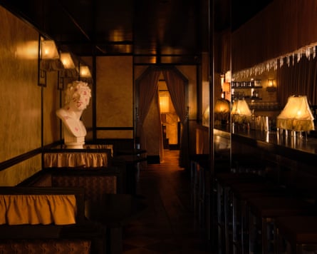 Interior of a bar with low lighting and a bust of El