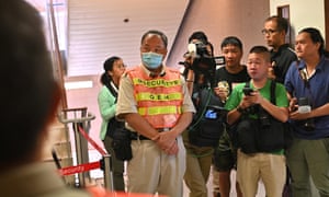 A group of reporters stand outside the intensive care unit of Queen Elizabeth Hospital in Hong Kong where Chow Tzk-lok died