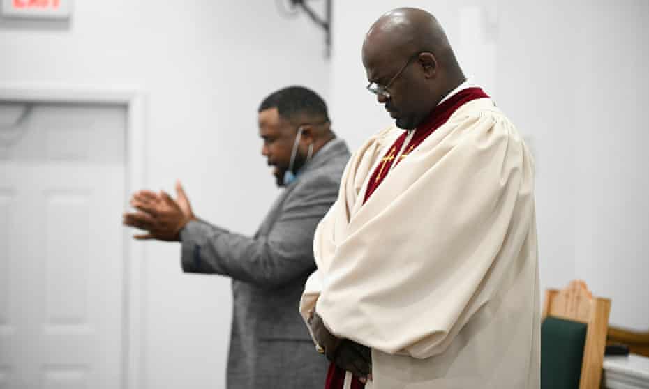 Reverend Kenneth B Thomas Sr. prays before preaching in the Sunday service on August 8, 2021.