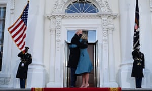 Joe Biden hugs First Lady Jill Biden as they arrive at the White House in Washington, DC.