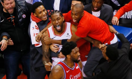 Kawhi Leonard is swamped by teammates after his shot beat the 76ers in Game 7 of the Eastern Conference semi-finals