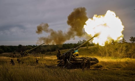A Ukrainian military unit in a field fires self-propelled artillery near a frontline in the Ukraine's Kharkiv region