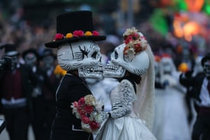Artists perform in a Day of the Dead parade in downtown Mexico City