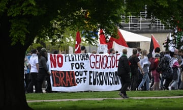 Pro-Palestinian protesters opposing Israel's participation in the Eurovision Song Contest demonstrate in Malmo. A banner reads 'No platform for genocide' and 'Israel out of Eurovision'