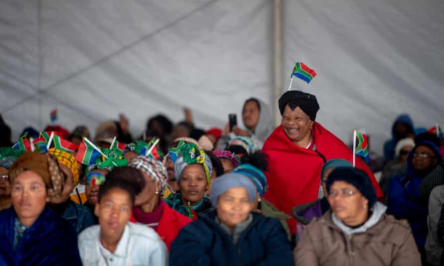 People gather in a tent at Mbekweni Rugby Stadium