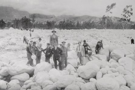 Group of men in mono pic of rock swept down from the mountains after glacial lake outburst flood in 1941 in city of Huaraz.