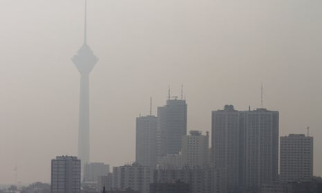 Tehran’s Milad tower behind a blanket of brown-white smog