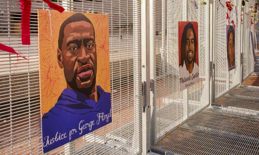Portraits of black people killed by police are seen on a fence around the Hennepin County Courthouse.