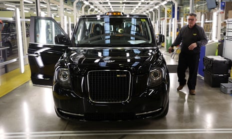 A worker walks along the TX electric taxi production line inside the LEVC (London Electric Vehicle Company) factory in Coventry.