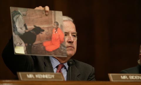 biden holds up photo of soldier with dog in front of detainee