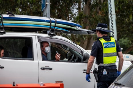 A police officer patrols and checks for entry permits to Victoria at a border checkpoint in Mallacoota on 31 December.