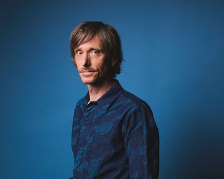 Mackenzie Crook in dark blue shirt.