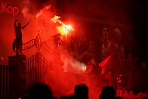More flares go off outside Anfield.