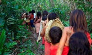 Araweté women walking to a sweet potato garden.