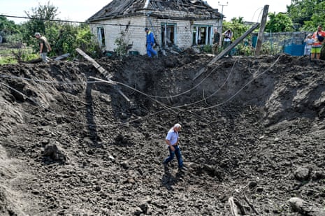 A man walks in a huge crater caused by Russian shelling in Zaporizhzhia region, southeastern Ukraine.