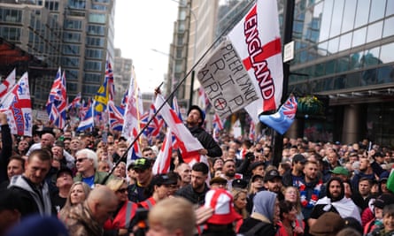 Supporters of a Pro-UK rally endorsed by Tommy Robinson march from Victoria Station to Parliament Square.