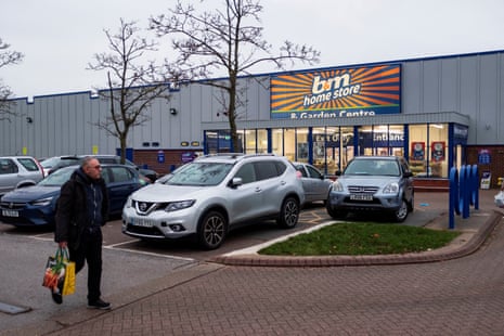 A person walks through the car park of a B&M store in London.