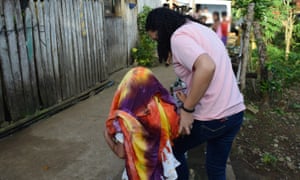 A child is led to safety during a joint operation between the International Justice Mission and Philippine law enforcement