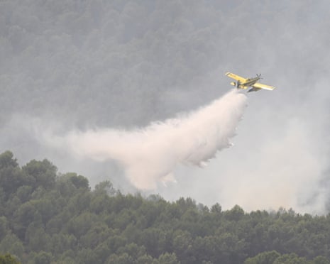 An airplane works to extinguish a wildfire near Onda, one of the towns affected by the forest fire of the La Vall d'Uixo area in Castellon, Spain.